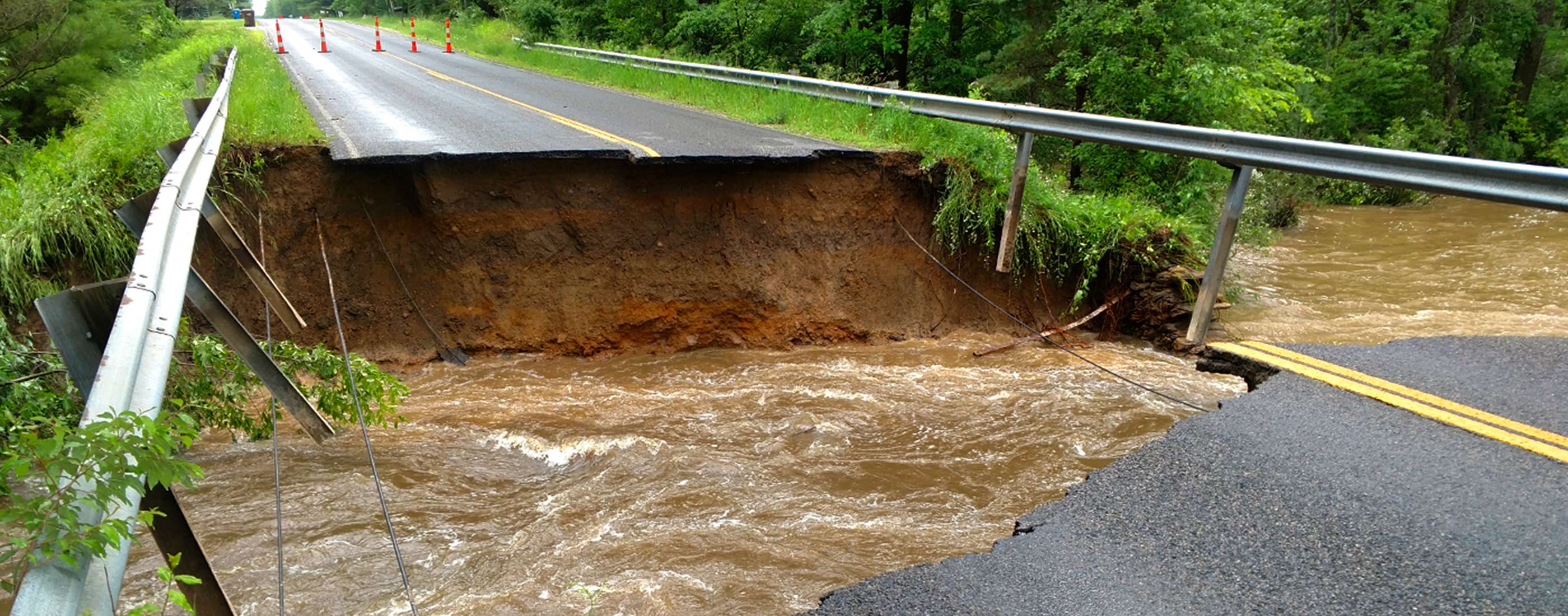 Extensive roadway damage in Midland County, Michigan after flooding.