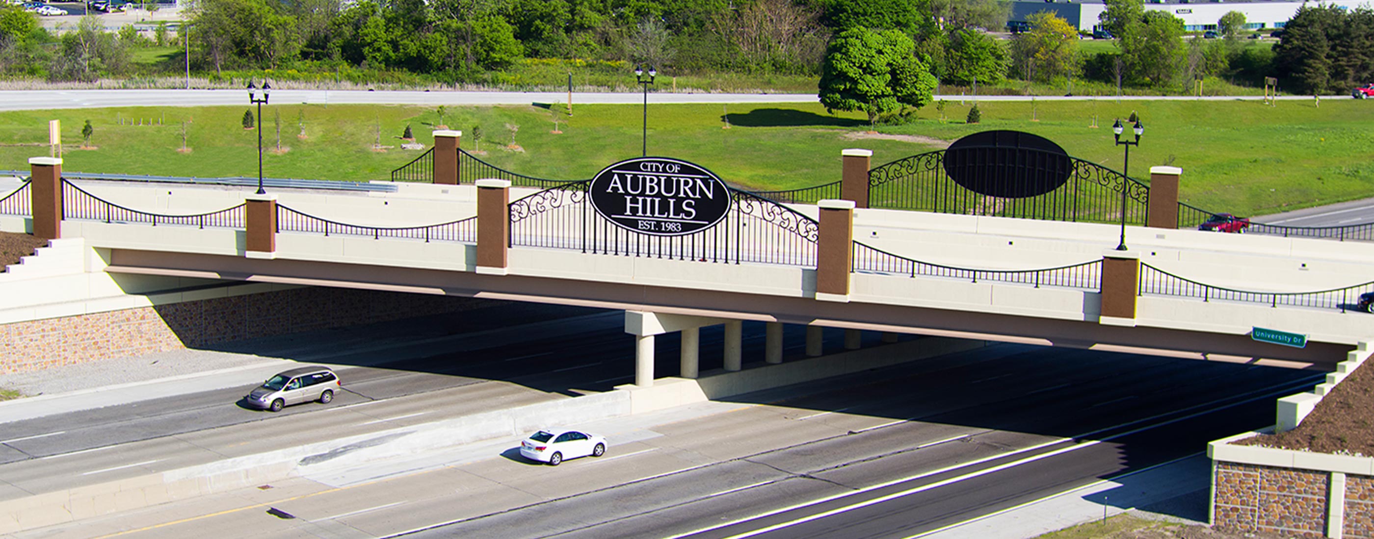 The main entryway to Auburn Hills, MI, redesigned by OHM Advisors, allows pedestrians to cross the bridge over I-75 safely.