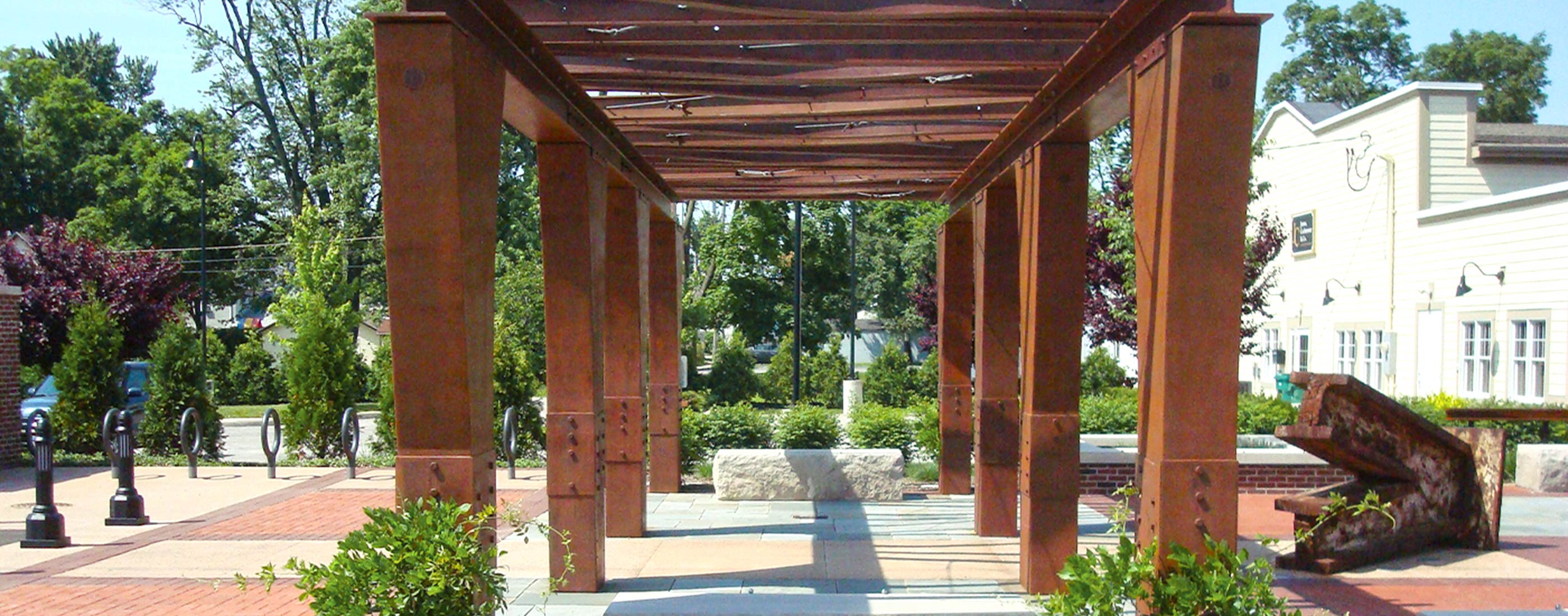Trellis, surrounded by stone and brick seating areas, incorporates steel from towers of World Trade Center.