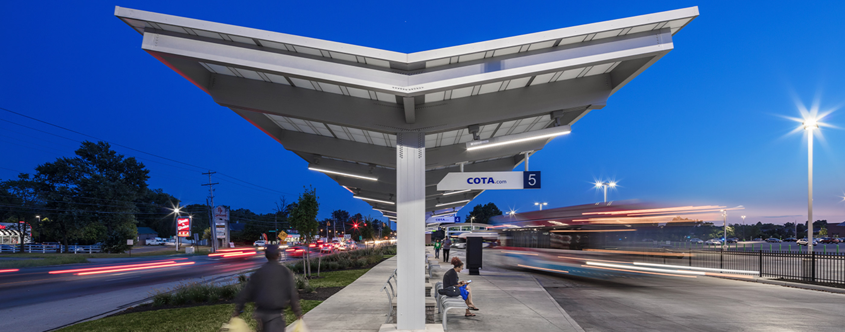 Residents and workers wait under shelter to use COTA's CMAX bus rapid transit.