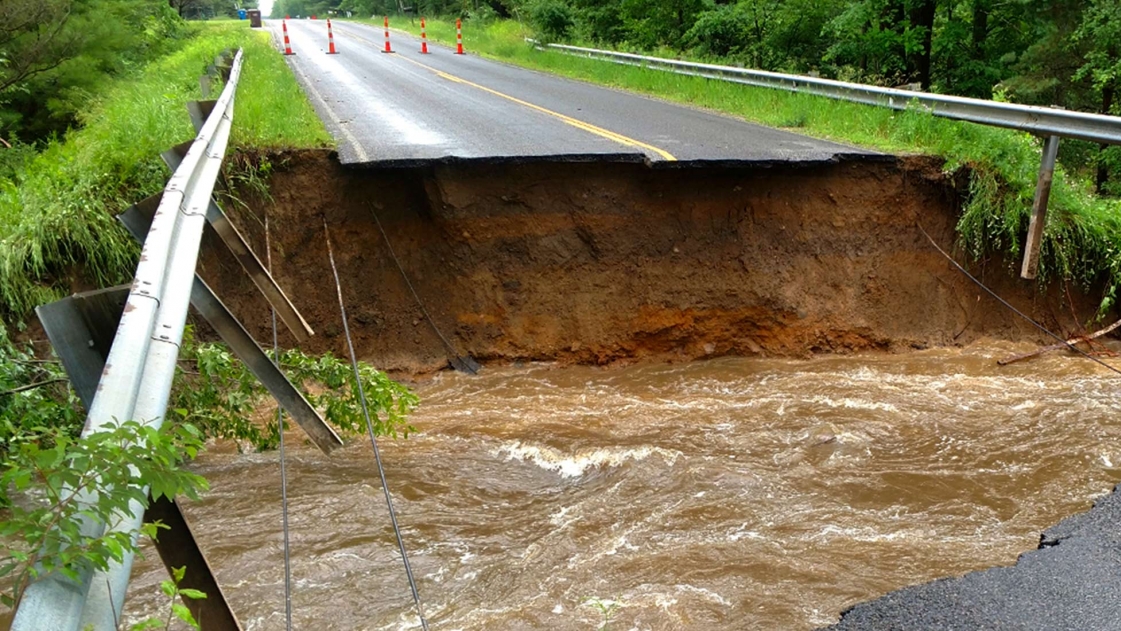 Extensive roadway damage in Midland County, Michigan after flooding.