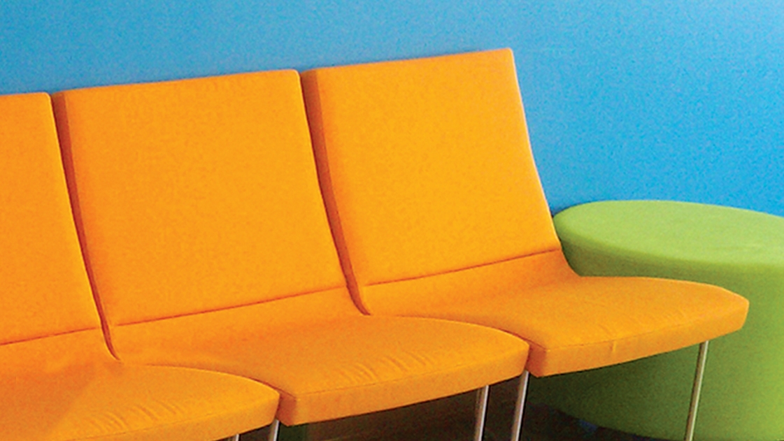 Bright orange chairs in a student-centered learning environment.