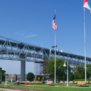 Canadian and American flags wave near the Blue Water Bridge.