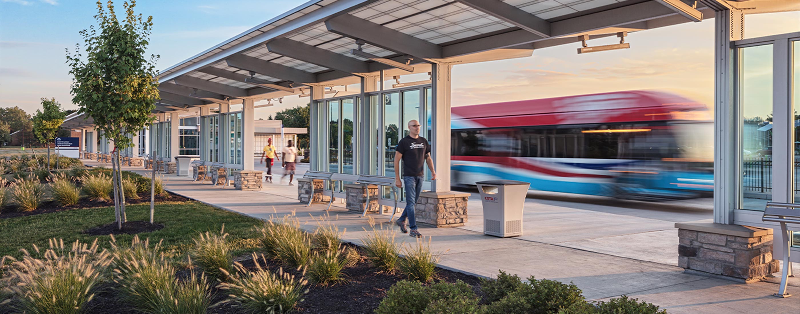 Pedestrians walk COTA's Northland Transit Center Park and Ride.