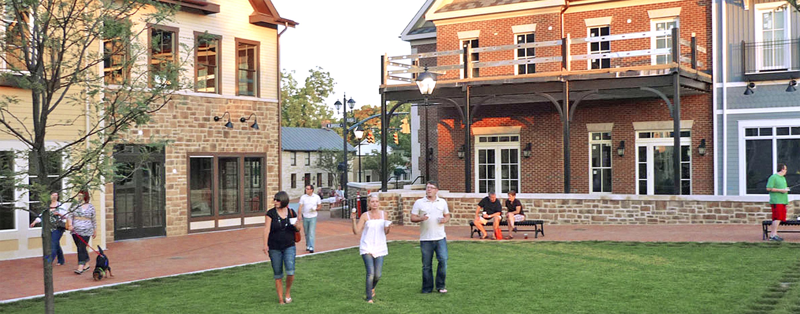 Pedestrians walk within BriHi Square's historic downtown.