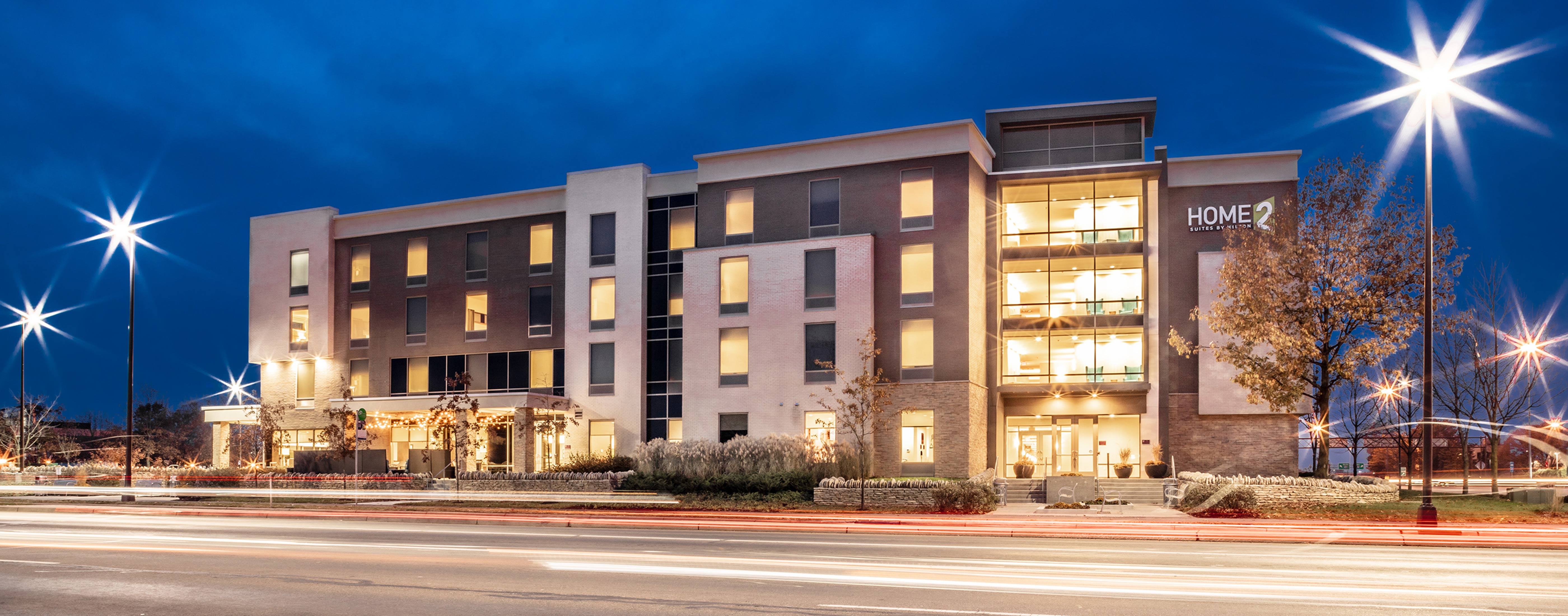 A nighttime view of the modern Hilton HOME2 Hotel, designed by OHM Advisors.