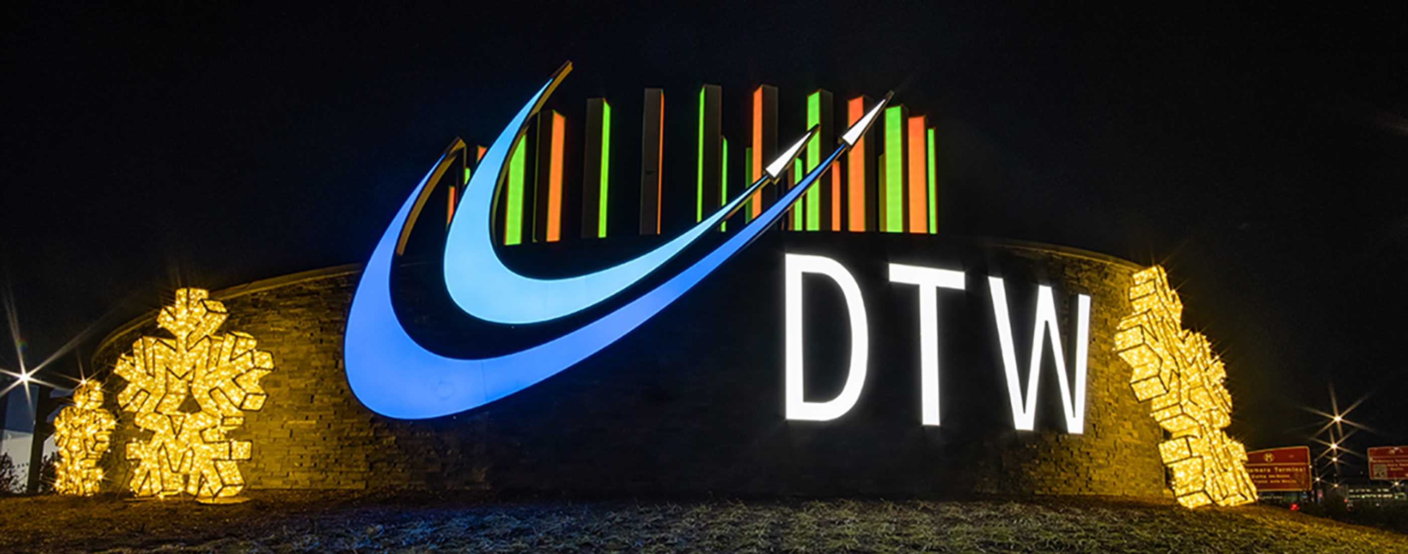 The Detroit Metropolitan Airport sign lit up with snowflakes.