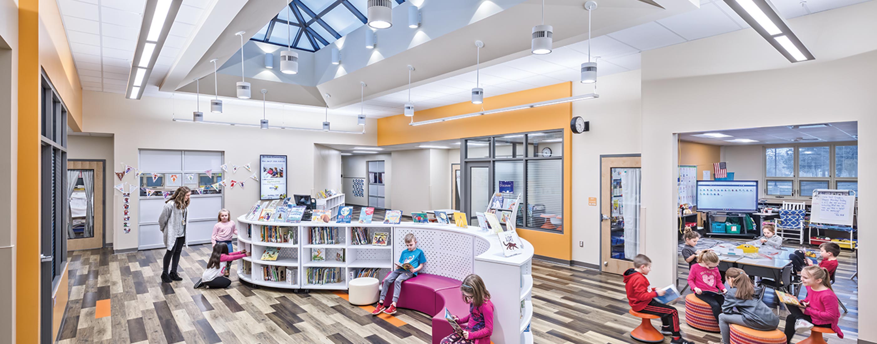 Children read books under expansive skylights in the Buckeye Valley East Elementary School.