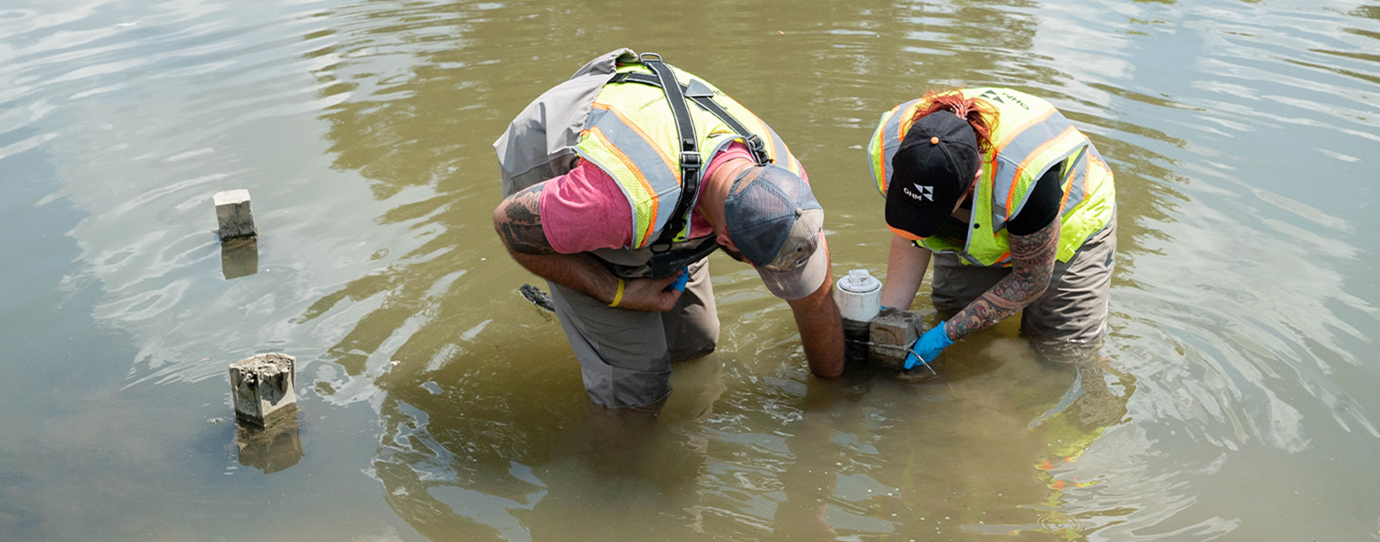 OHM staff working with equipment on Clinton River