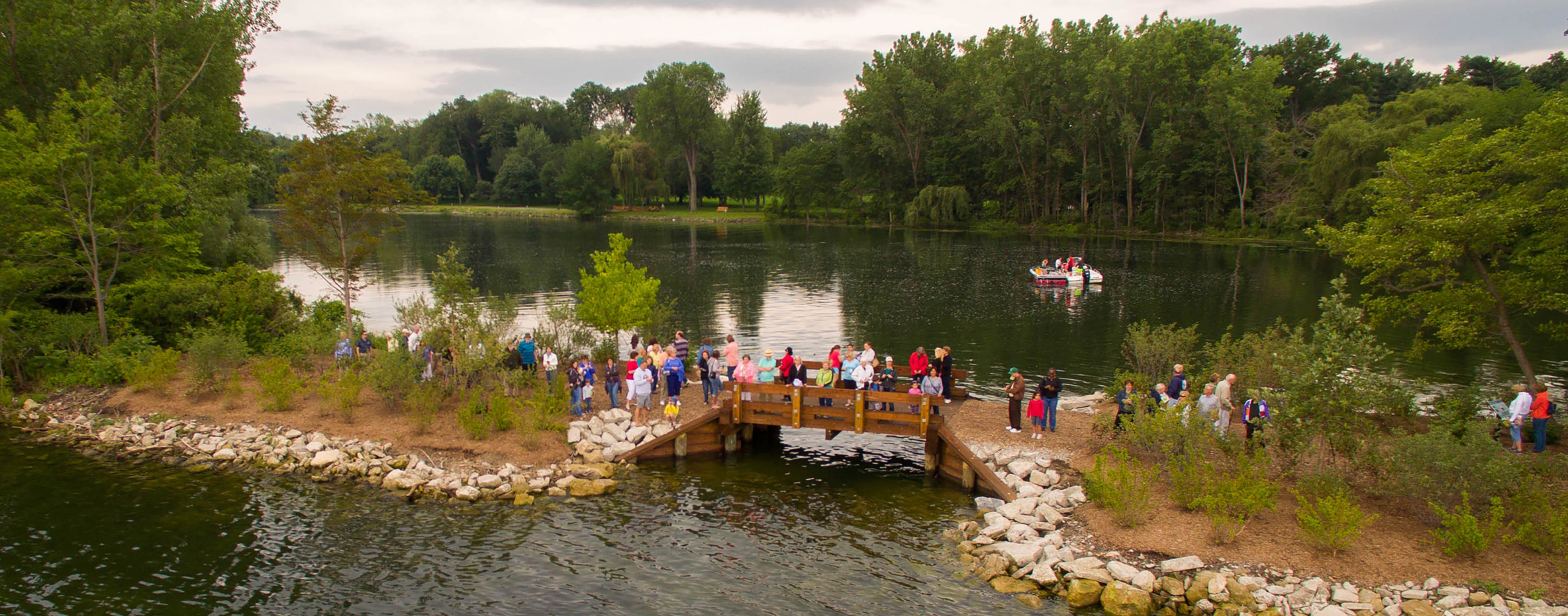 People crossing a bridge along the shoreline