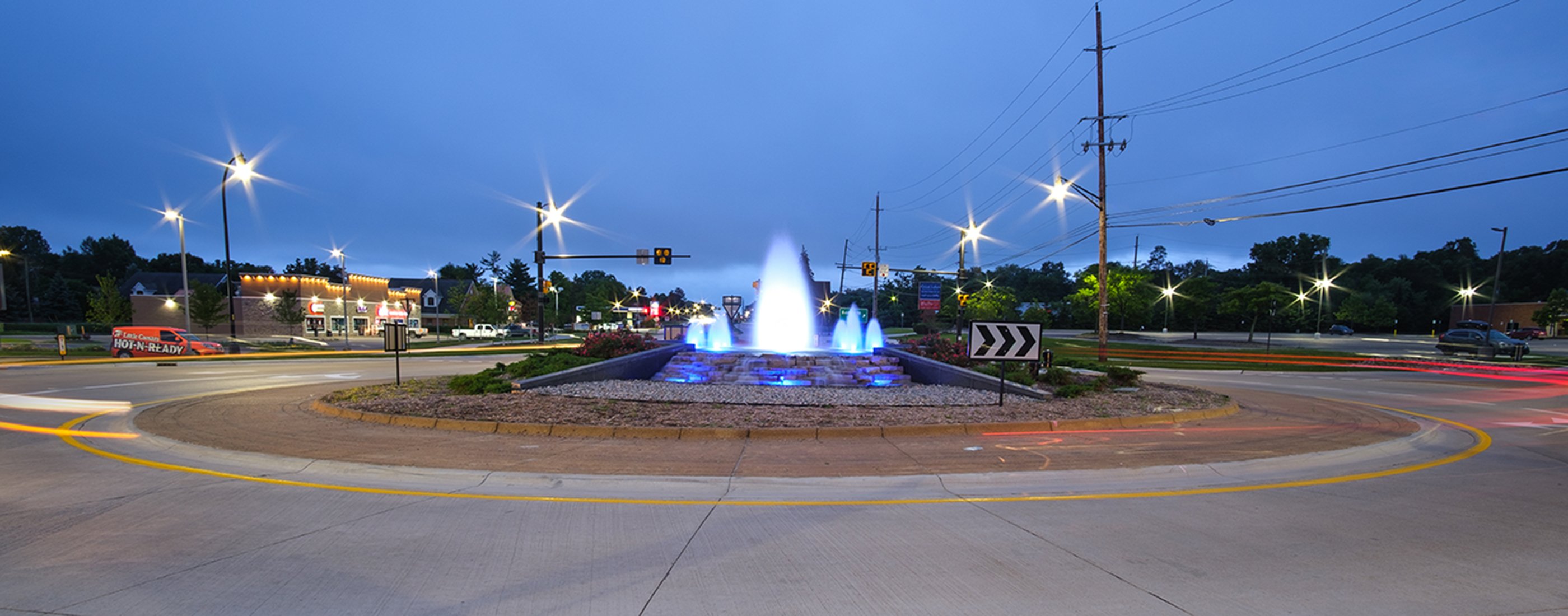 Illuminated Baldwin Road roundabout at night.