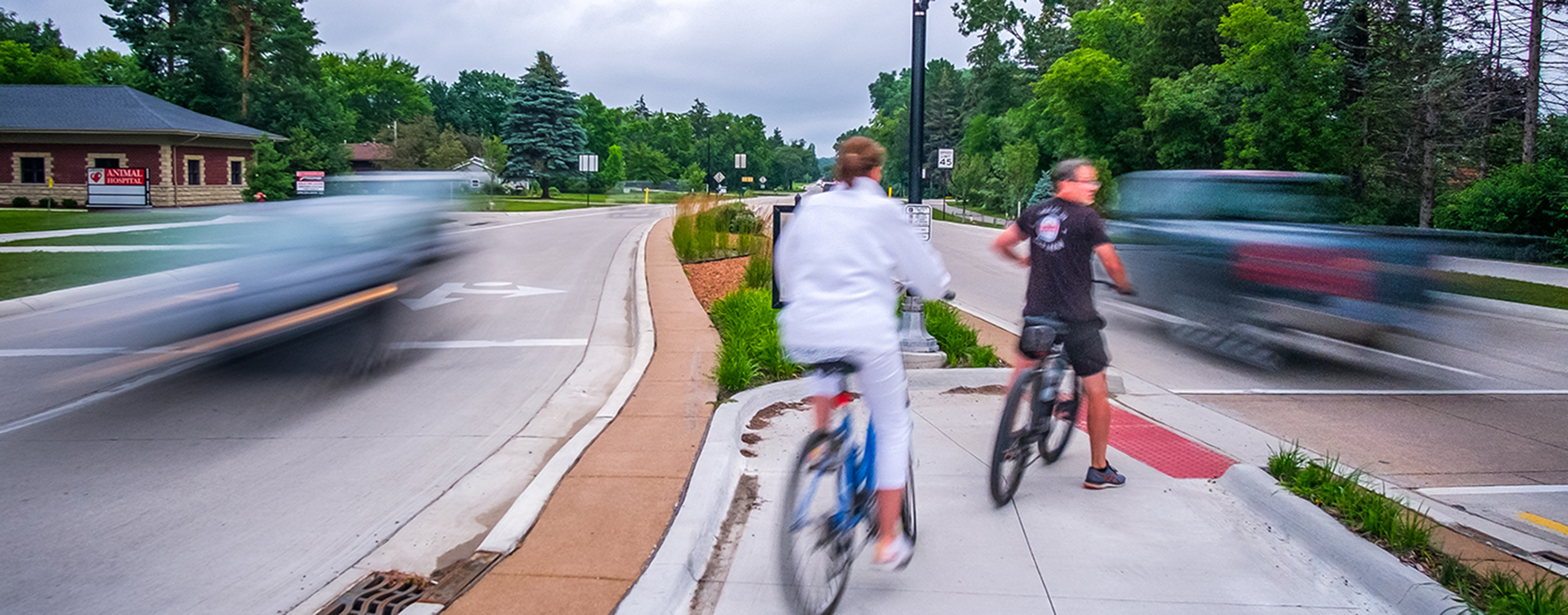 Cyclists stopped at one of the many new median crosswalks along Baldwin Road.