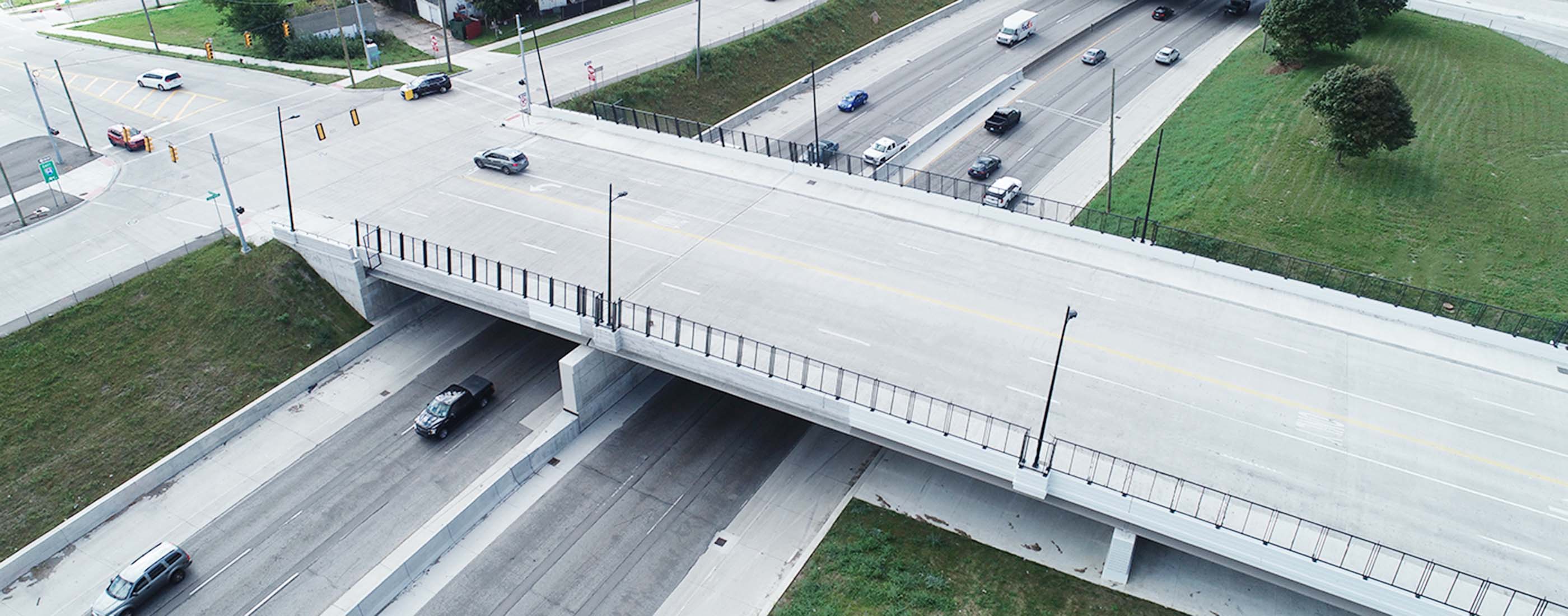 The newly reconstructed bridge is a three-span structure carrying four lanes of traffic with bike lanes and sidewalks.