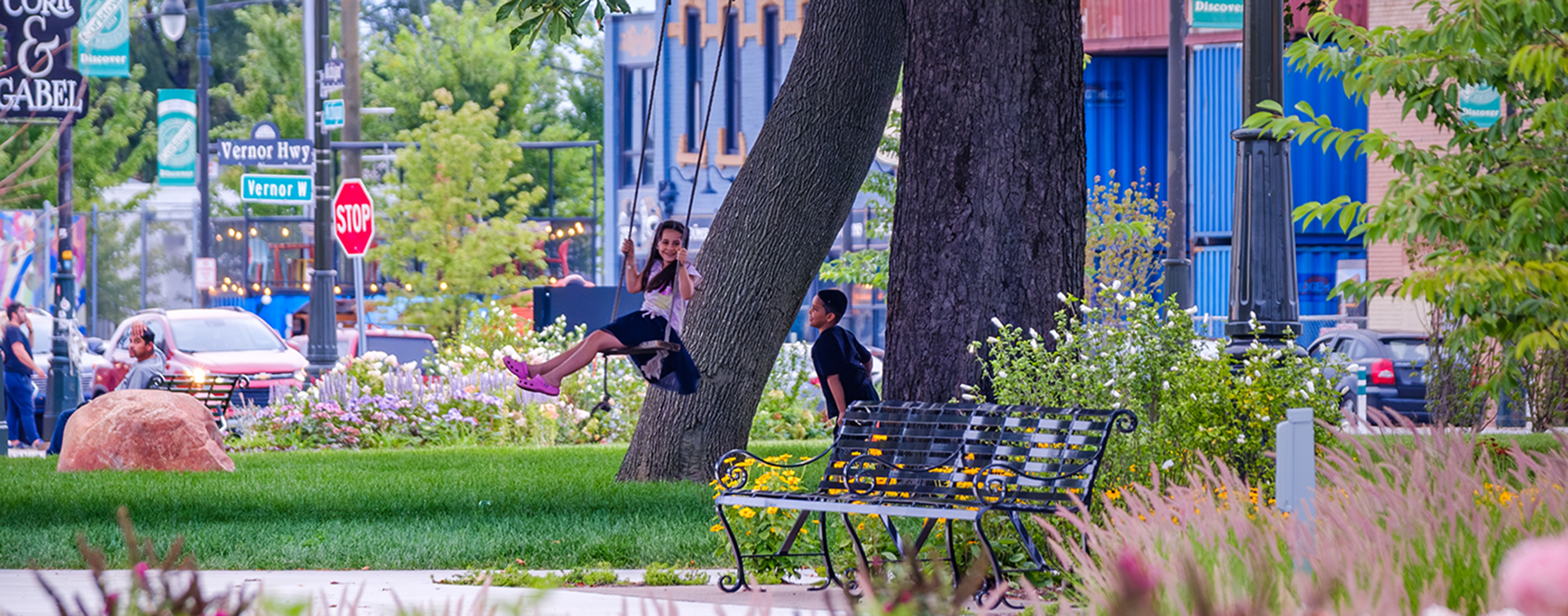 Children play on one of the tree swings in Roosevelt Park