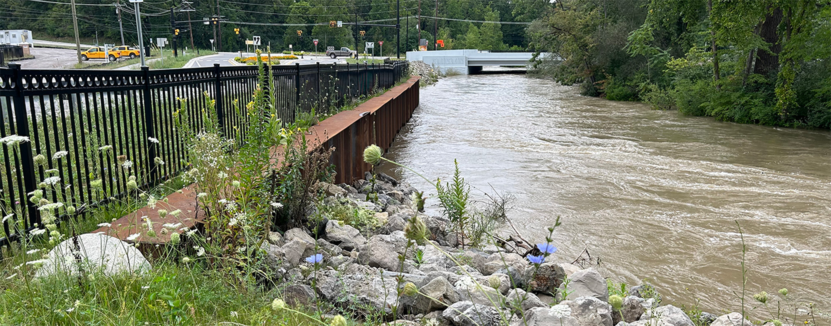 Retaining walls, stone, and plantings help prevent erosion along the banks of the Clinton River.