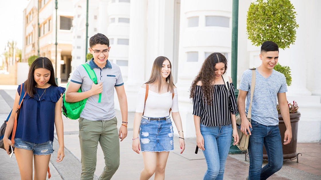 Young adults walk through mixed-use development.