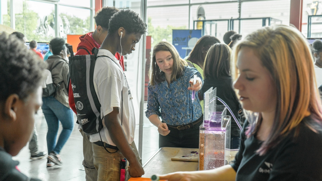 OHM Advisors employees interact with students at the Detroit Construction Science Expo.