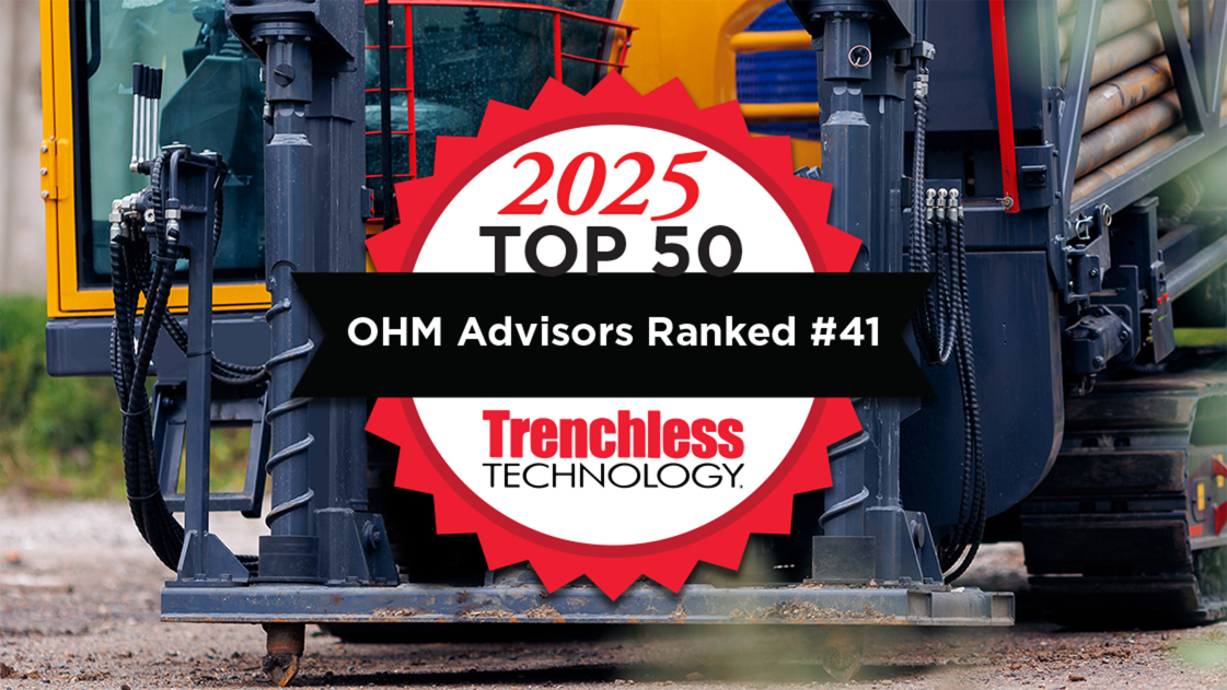 Heavy machinery with logo indicated that OHM Advisors is ranked 41st on Trenchless Technology list of engineering firms for 2025. 