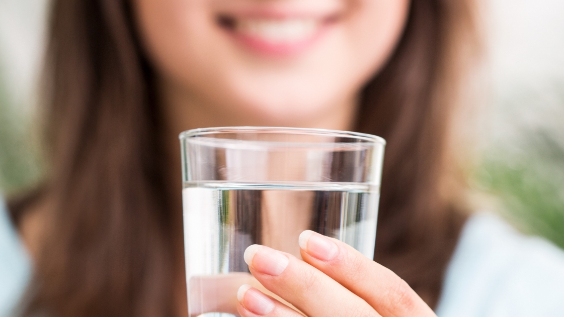 Woman with glass of drinking water