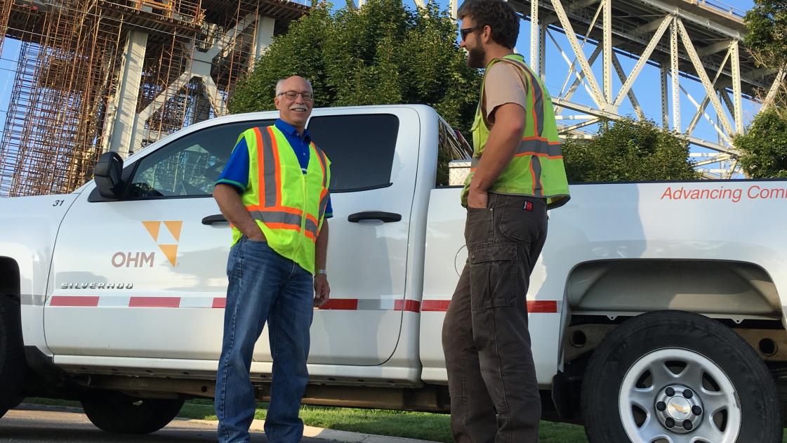 Dan Fredendall, VP of OHM Advisors, stands in front of an OHM truck
