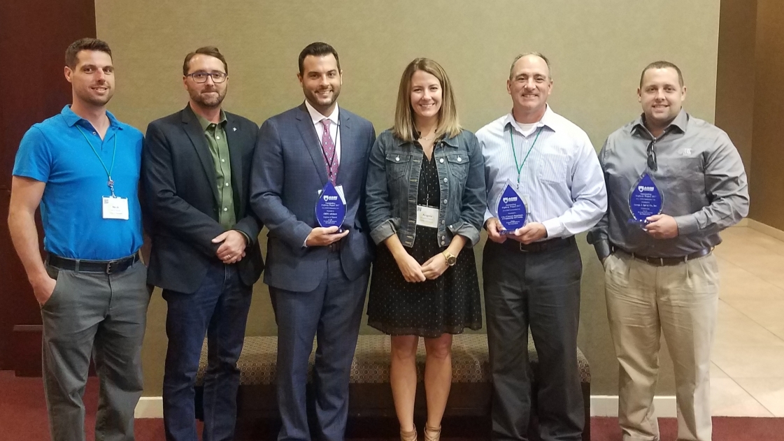 OHM Advisors employees accept the 2018 Great Lakes Region of the ASHE Award