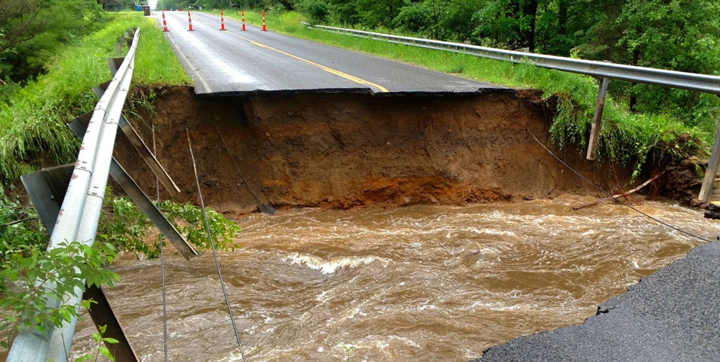 Extensive roadway damage in Midland County, Michigan after flooding.