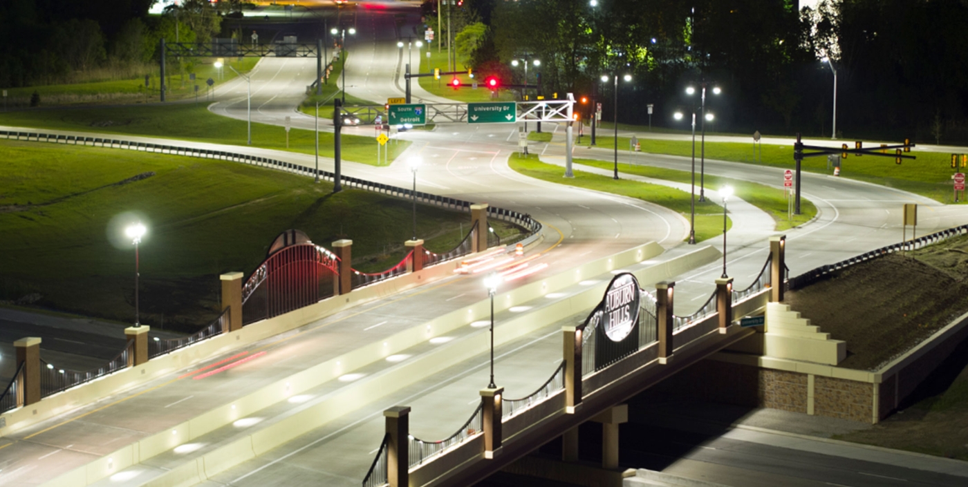 Bright lighting allows pedestrians to cross the bridge in Auburn Hills over I-75 safely.