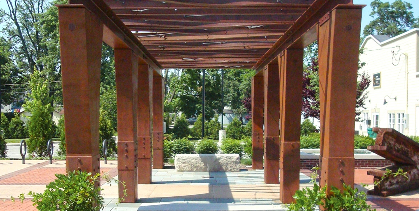 Trellis, surrounded by stone and brick seating areas, incorporates steel from towers of World Trade Center.
