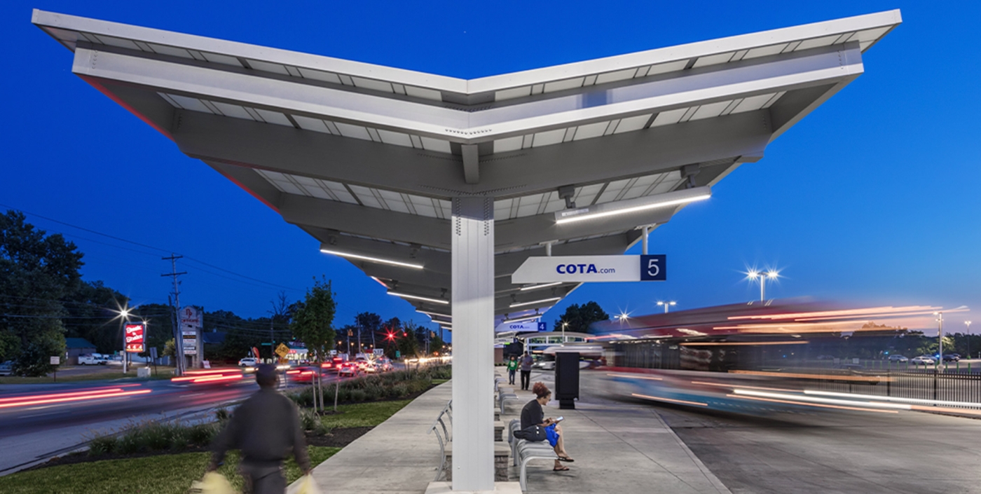 Residents and workers wait under shelter to use COTA's CMAX bus rapid transit.