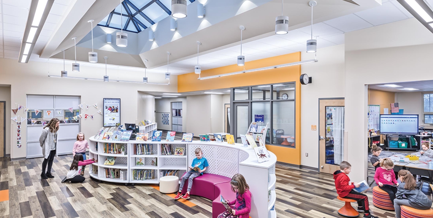 Children read books under expansive skylights in the Buckeye Valley East Elementary School.
