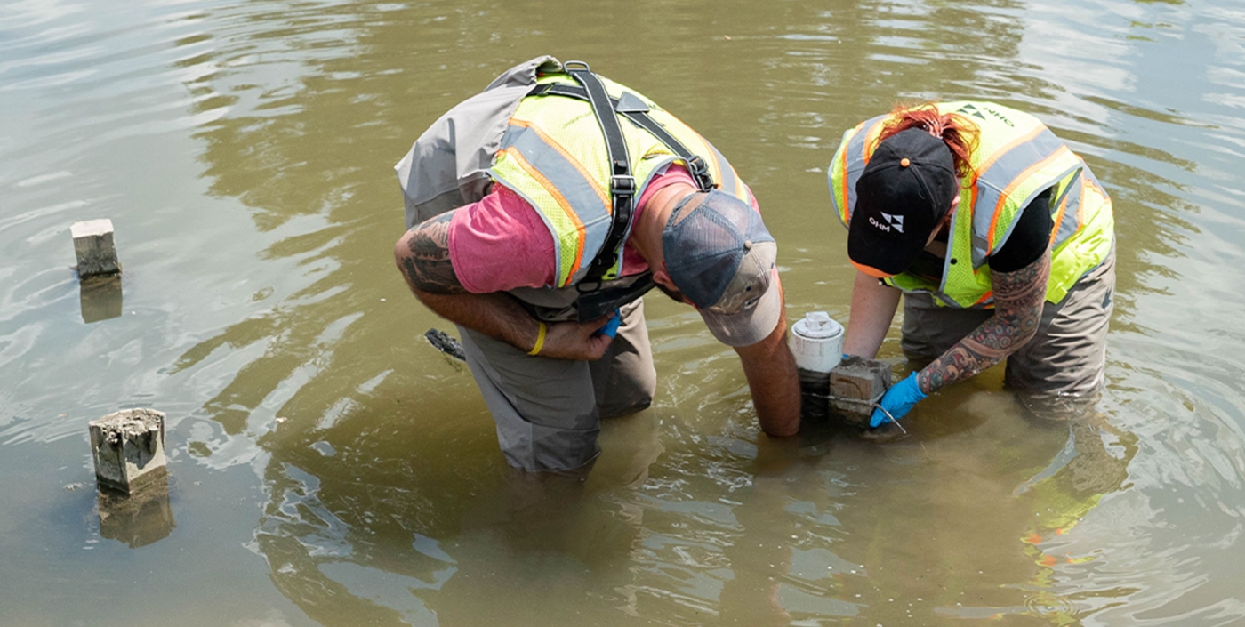 OHM staff working with equipment on Clinton River