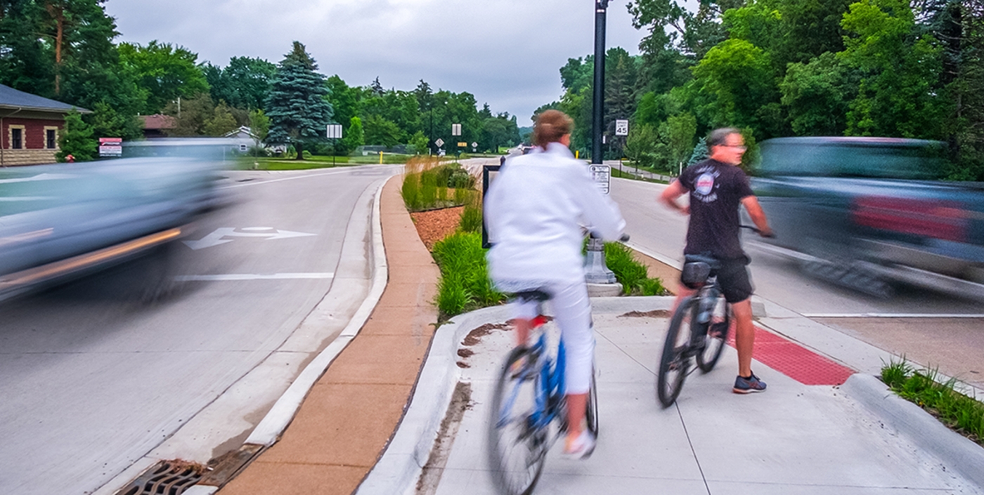 Cyclists stopped at one of the many new median crosswalks along Baldwin Road.