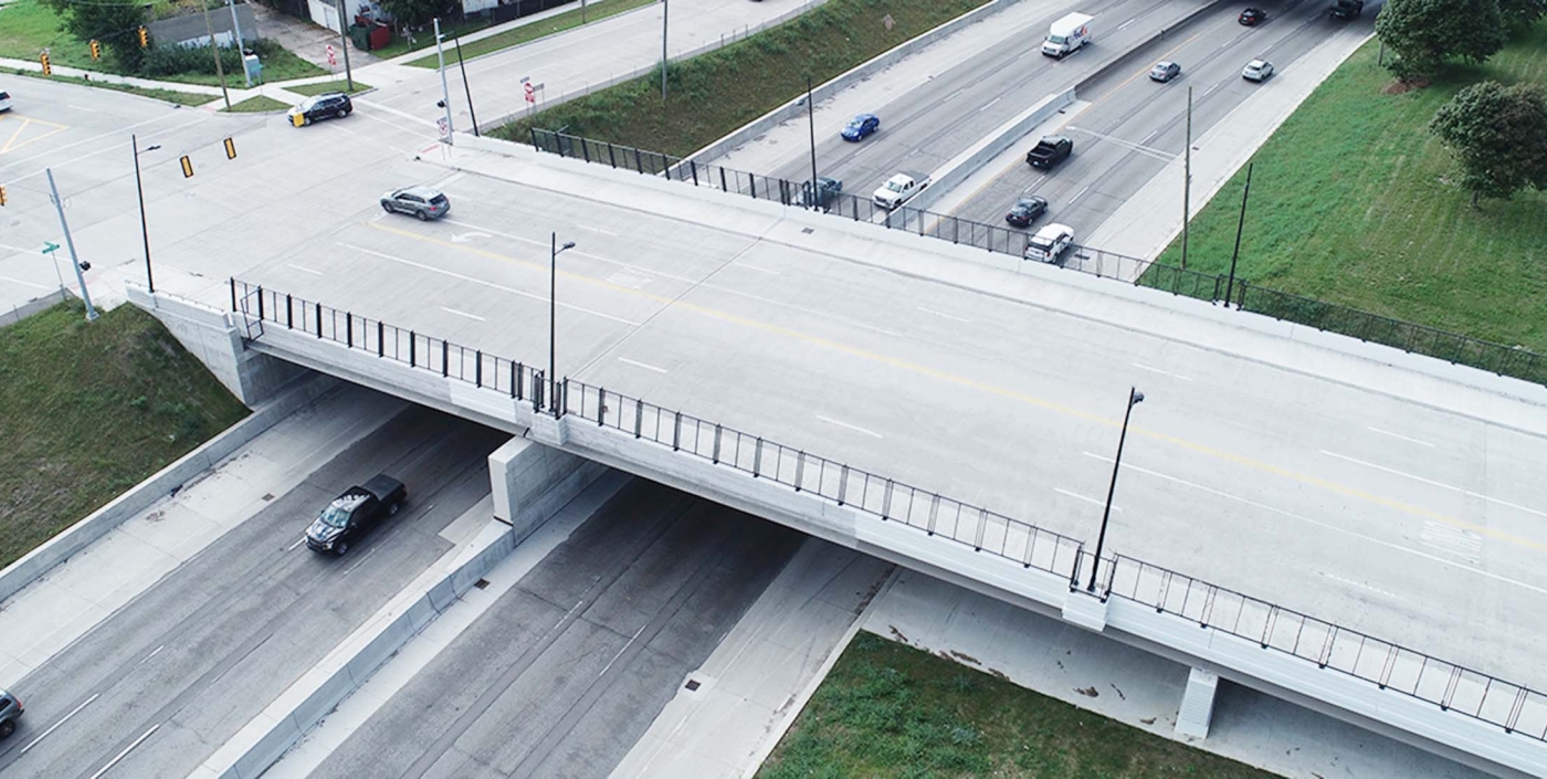 The newly reconstructed bridge is a three-span structure carrying four lanes of traffic with bike lanes and sidewalks.