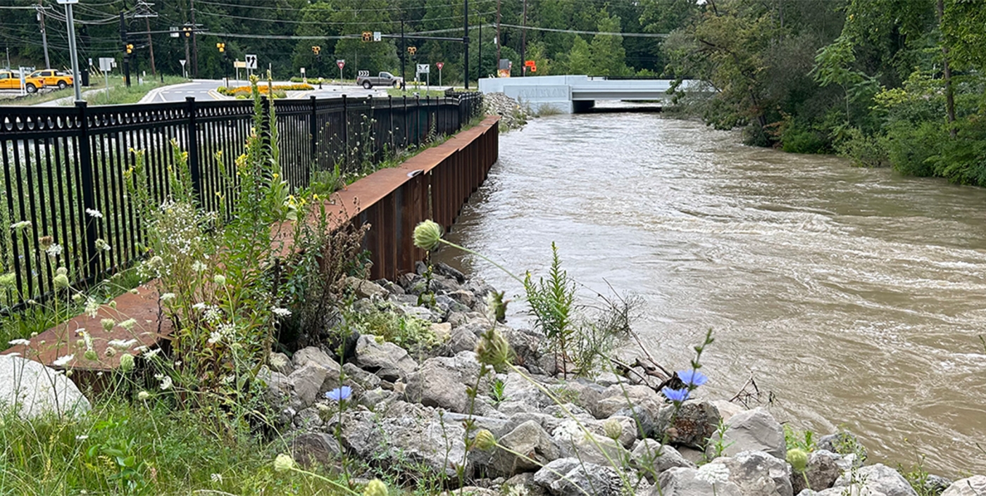 Retaining walls, stone, and plantings help prevent erosion along the banks of the Clinton River.