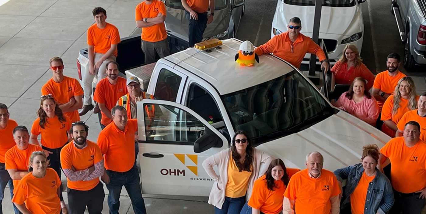 OHM Advisors Staff in Tennessee gathered around company vehicle.
