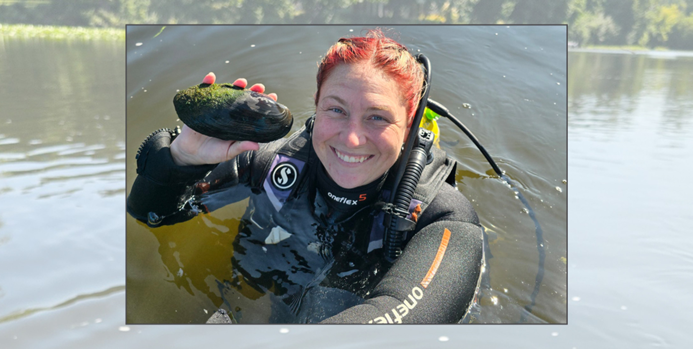 Female water environmentalist displaying a rock in a river