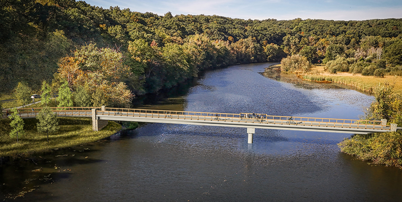 Bridge over river with green lush trees