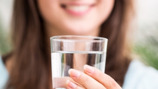 Woman with glass of drinking water