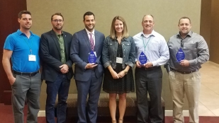 OHM Advisors employees accept the 2018 Great Lakes Region of the ASHE Award