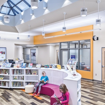 Children read books under expansive skylights in the Buckeye Valley East Elementary School.