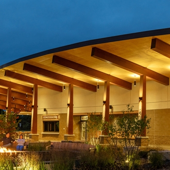 Night shot of mass timber pavilion and seating at Jeanne Stine Park in Troy, Michigan.