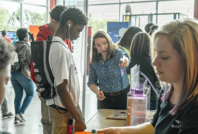 OHM Advisors employees interact with students at the Detroit Construction Science Expo.