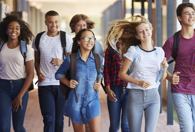 Young teenagers walk through a school designed with security.