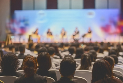 presenters on stage in front of live audience