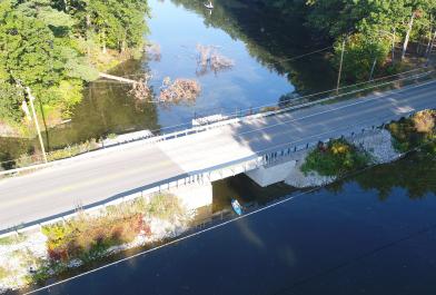 Someone kayaks under an updated Midland County, Michigan bridge.