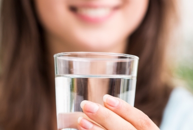 Woman with glass of drinking water