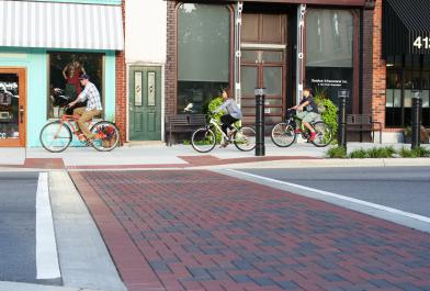 Pedestrians ride their bicycles throughout the Downtown Fenton Streetscape.