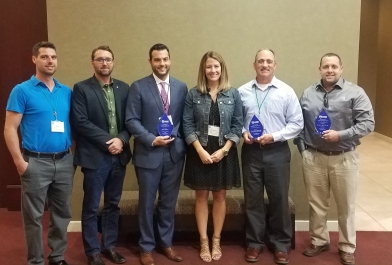 OHM Advisors employees accept the 2018 Great Lakes Region of the ASHE Award