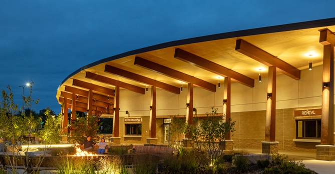 Night shot of mass timber pavilion and seating at Jeanne Stine Park in Troy, Michigan.