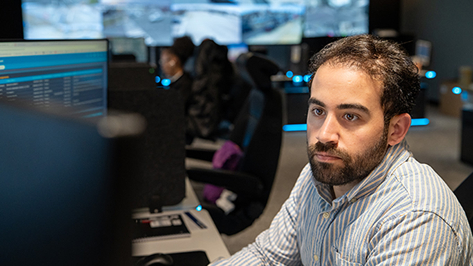 Male employee with beard focusing on computer screen